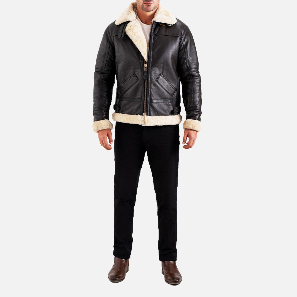 Man wearing a black leather jacket with white fur lining on a white background